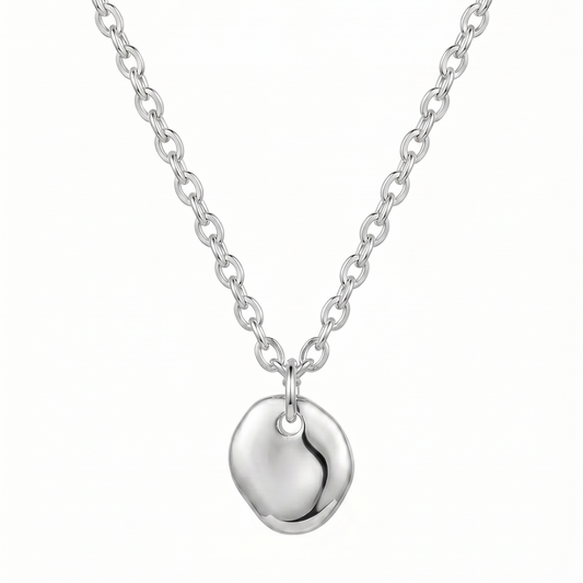 Silver necklace with a heart-shaped pendant on a white background